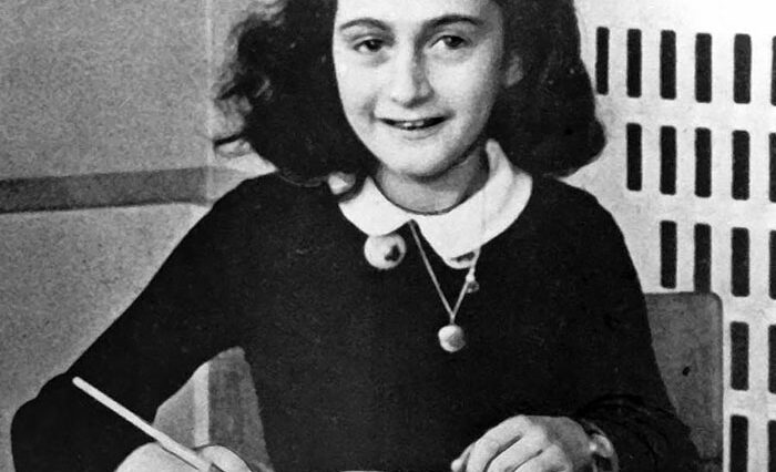 Anne Frank writing in her diary