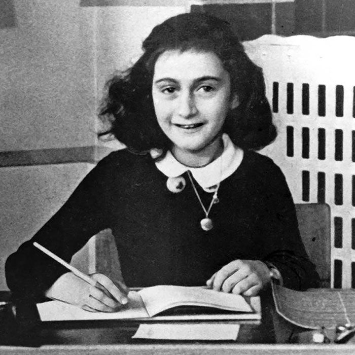 Anne Frank writing in her diary
