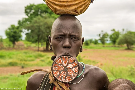 A woman sporting a lip plate, an African culture tradition