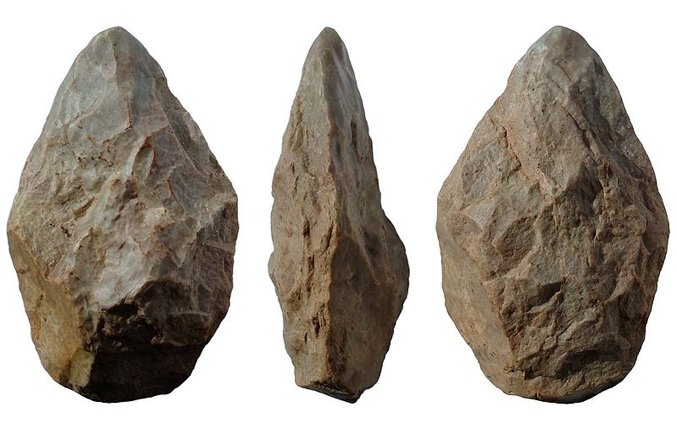 A rock chipped to have a pointed edge with three images of it from the front, side, and back
