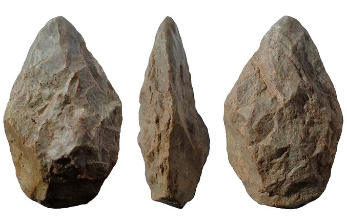A rock chipped to have a pointed edge with three images of it from the front, side, and back