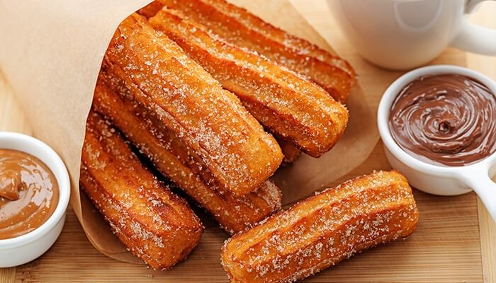 Churros, eating with chocolate dip