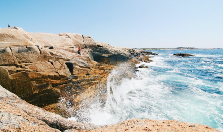 Waves crash upon a shore of a coastal area in Nova Scotia, Canada