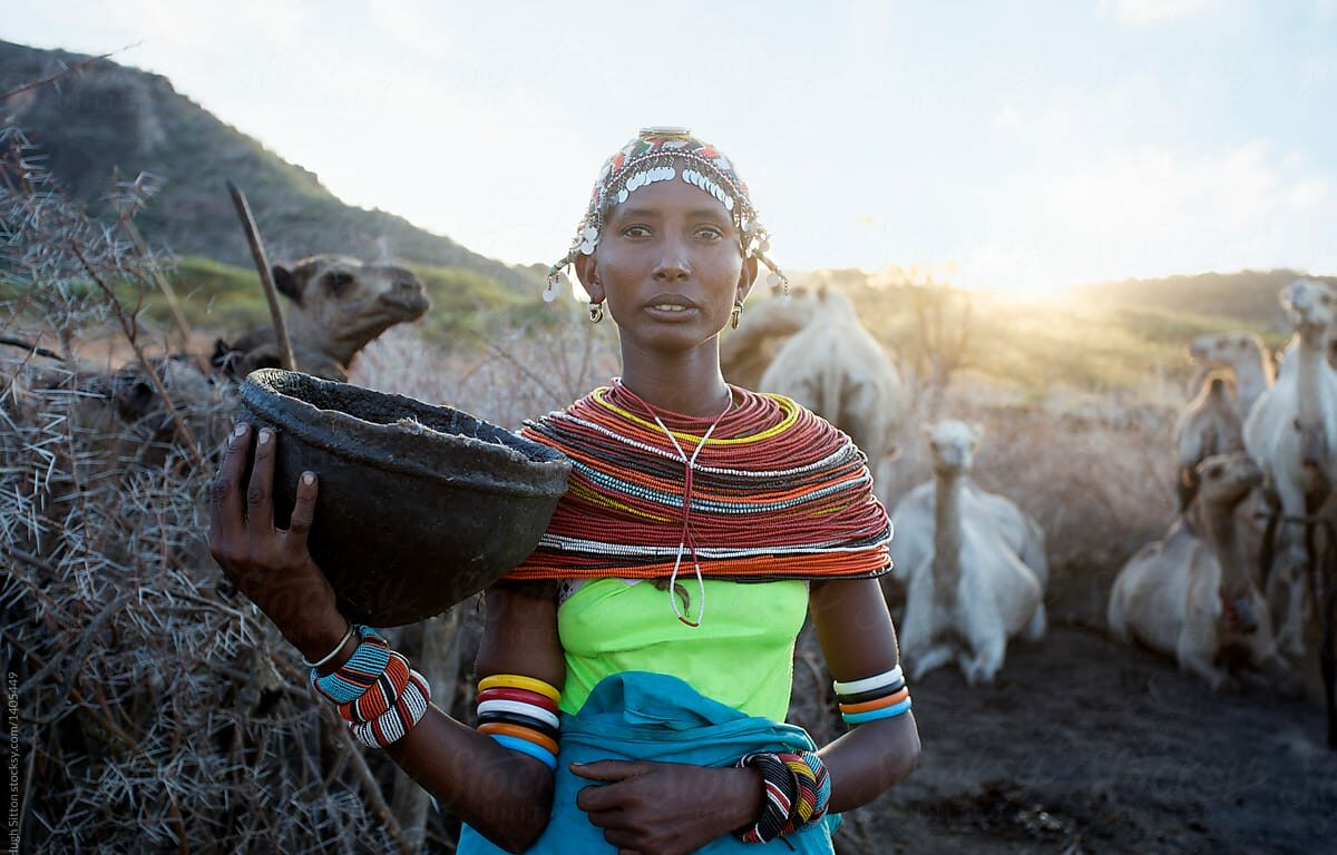 Samburu Women carrying pail of milk