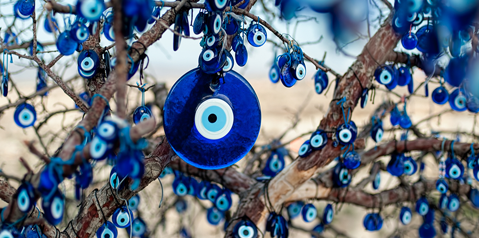 a coloured image of a tree decorated with glass blue eye beads