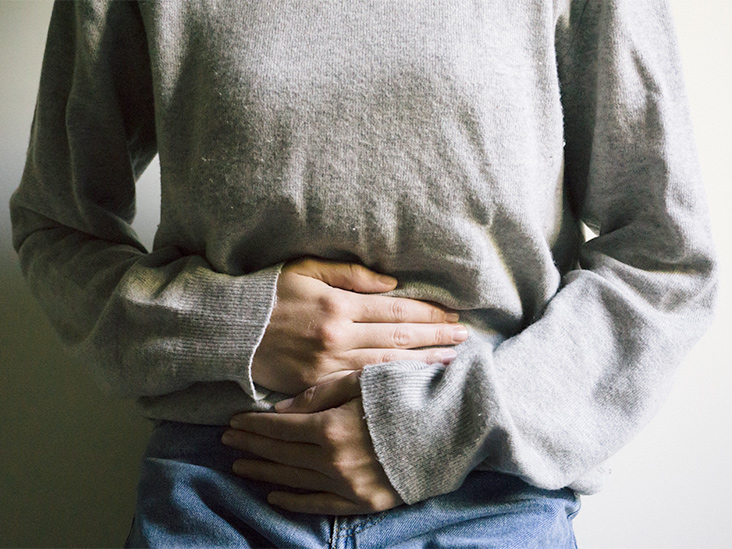 Woman clenching her stomach from endometriosis pain