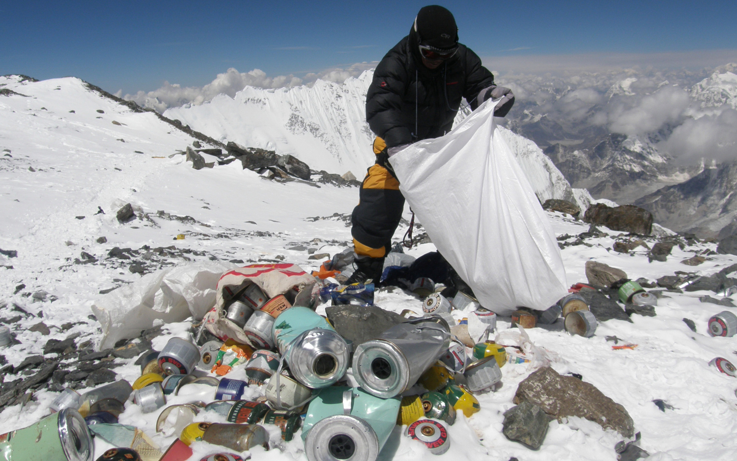 a Nepalese sherpa remocing trash from mount everest