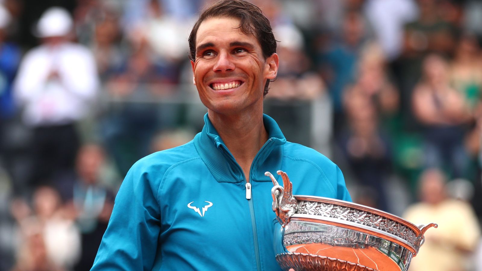 Tennis legend Rafael Nadal with trophy from victory at French Open tournament.