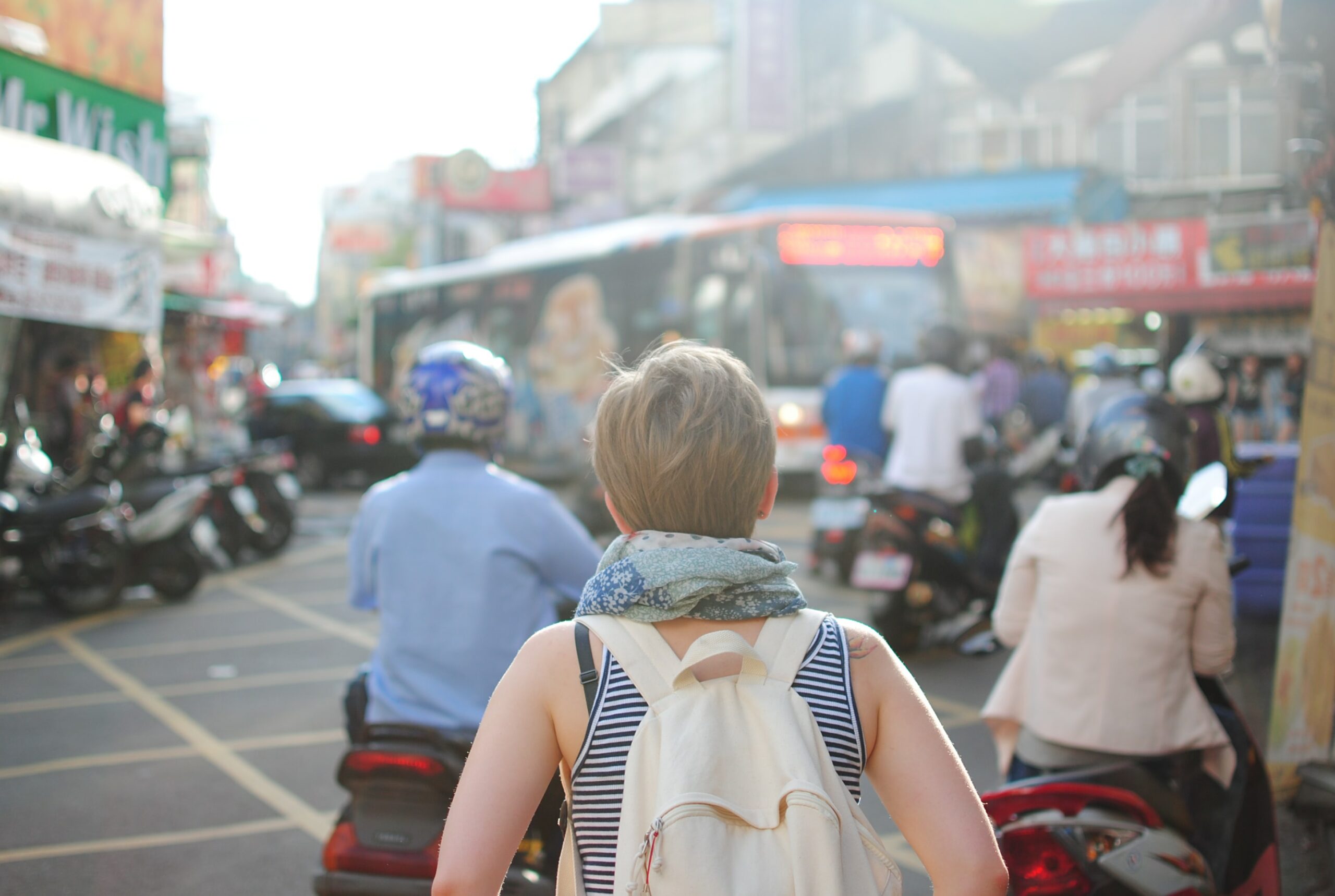 Color image of a tourist with a backpack on busy streets