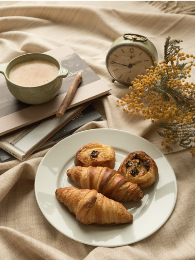 Puff pastries, with a drink, a clock, and flora