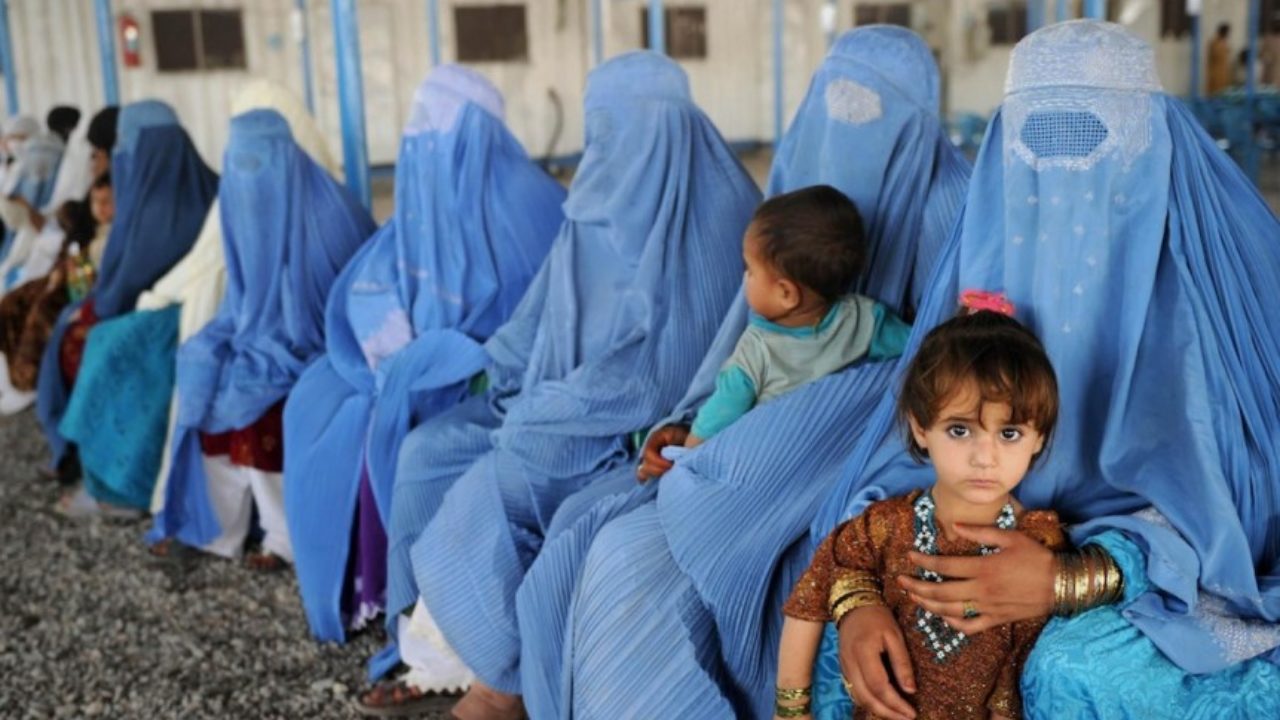 Afghan women clad in the blue burqa.