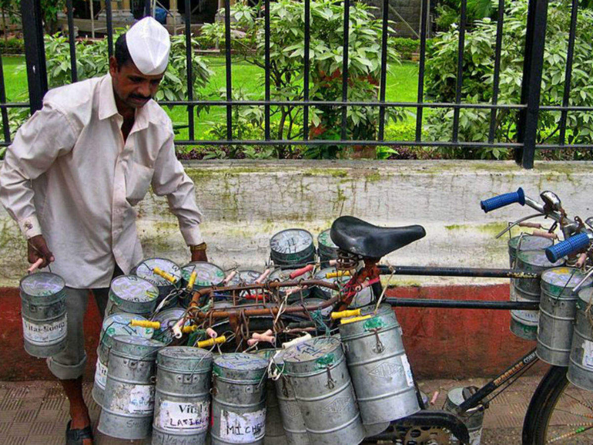 a dabbawala's cycle full of lunchboxes
