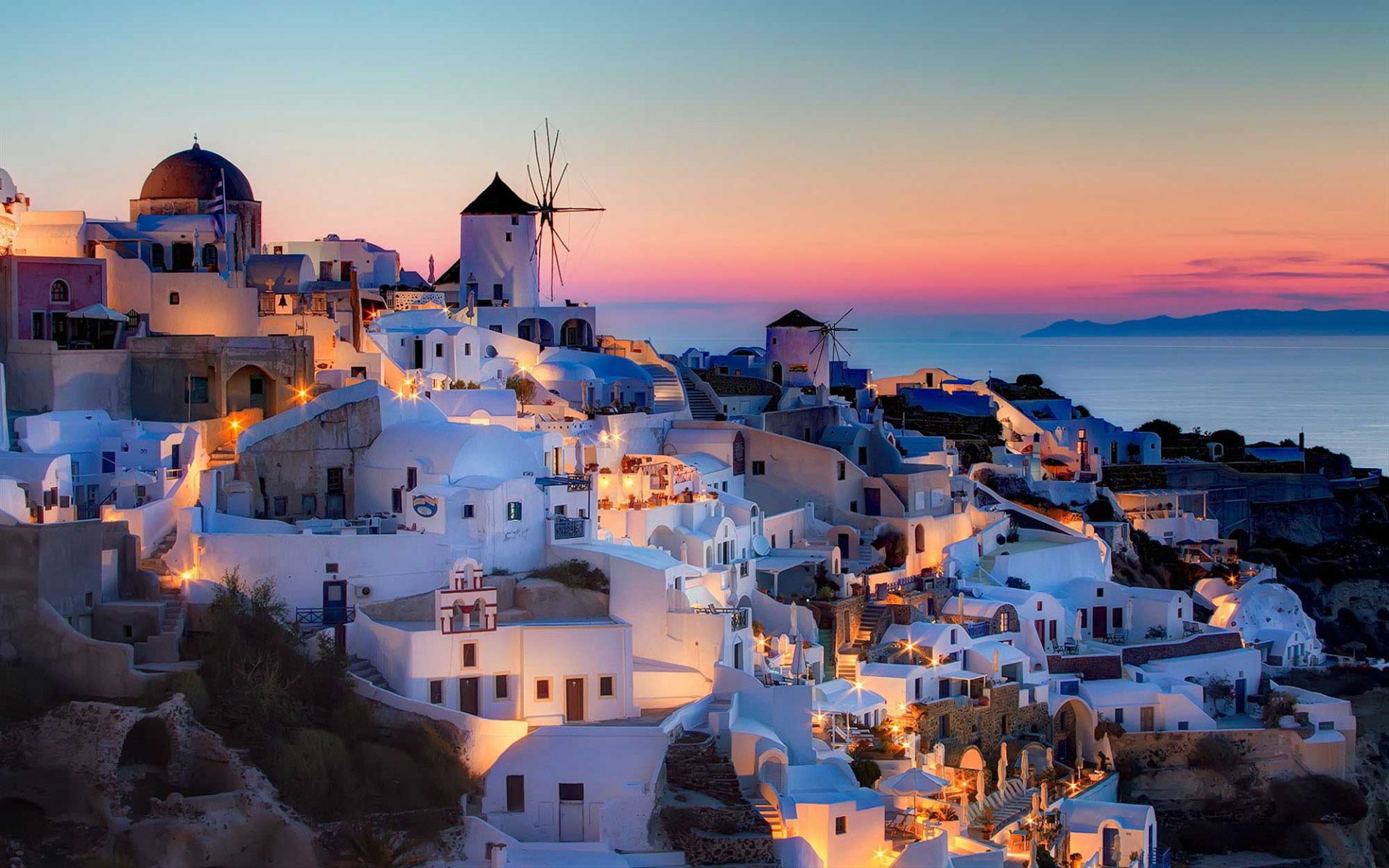 a colored image of Bodrum and white bodrum houses and windmill at the top during a sunset