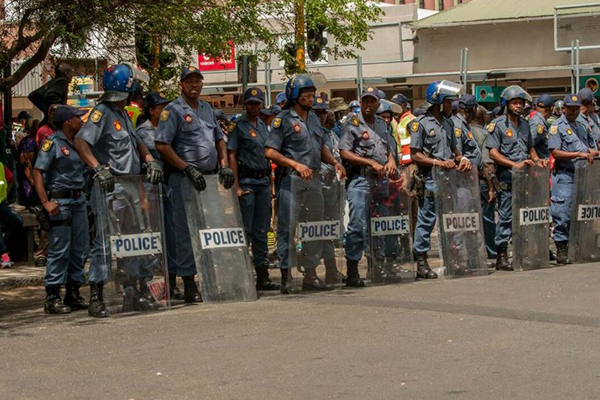 a group of African police aligned to hinder the public from moving further