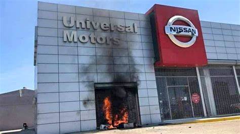 a colored image of a Nissan building set on fire by black people