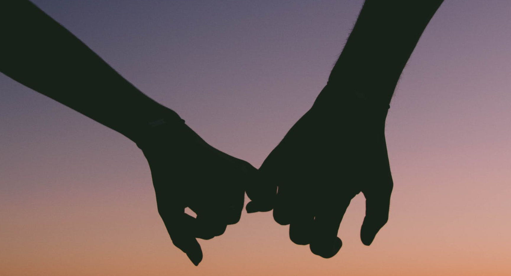 Silhouette of couple holding hand