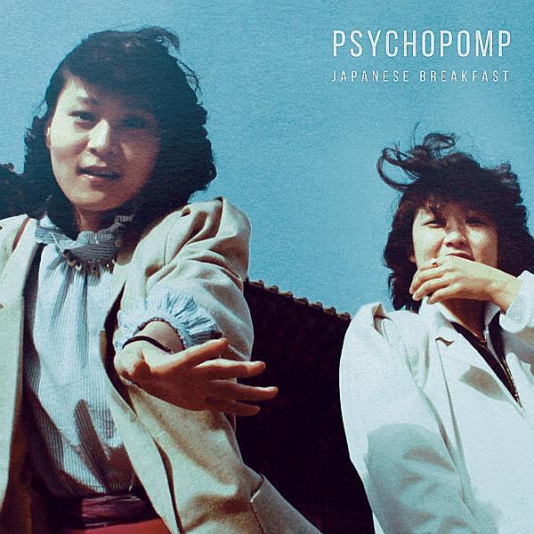 an album cover where two Korean women standing in an open space while the one on the left stretches her hand front