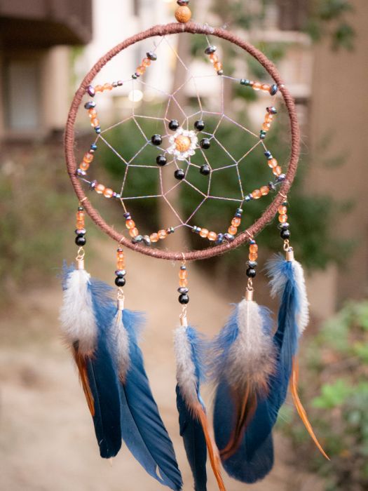 Beautiful dreamcatcher with beads and colourful feathers