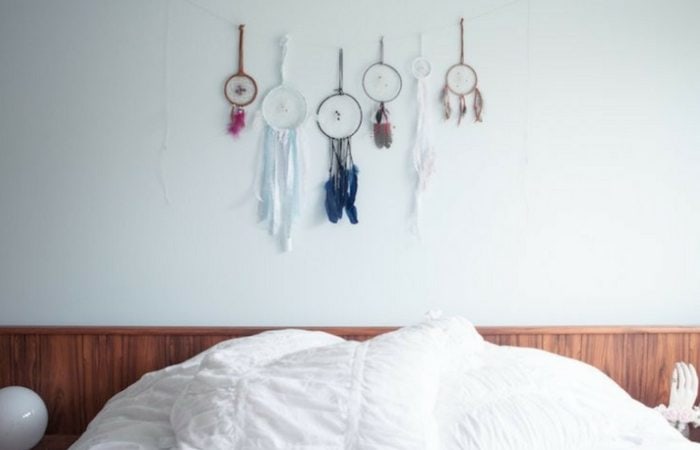 Several dreamcatchers hanging above kid's bed