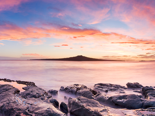 Rangitoto Island at sunset across the water. 