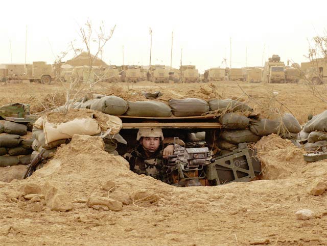 soldier in a foxhole ready to fight