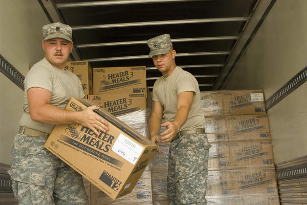 soliders carrying boxes of food supplies