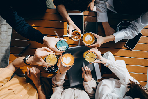 color image of top angle view of a group of corporate coworkers having drinks