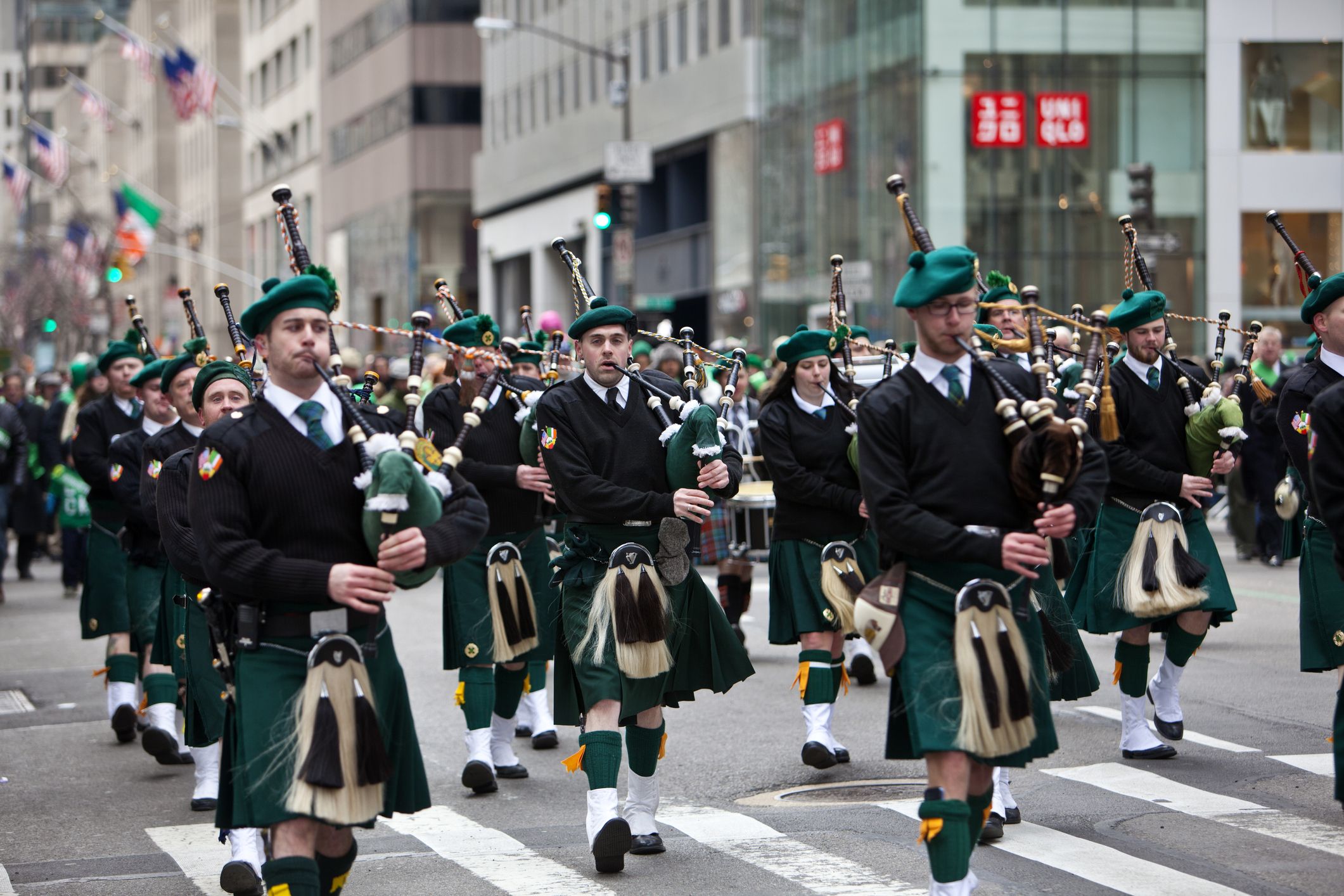 One of the St. Patrick's Day parads with men in traditional Irish clothing playing the uilleann pipes.