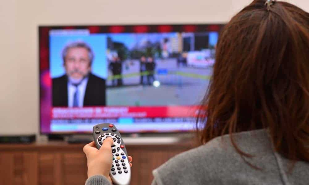 Colored image of a person watching news
