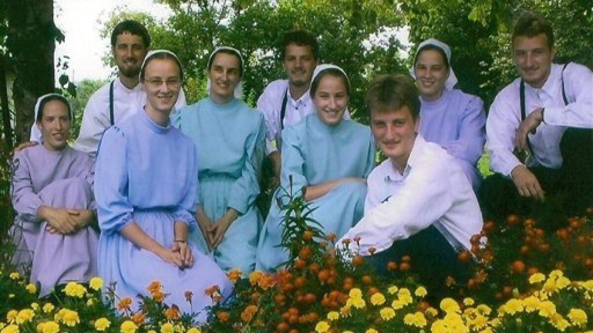 A photograph of male and female Mennonites in their appropriate dress.