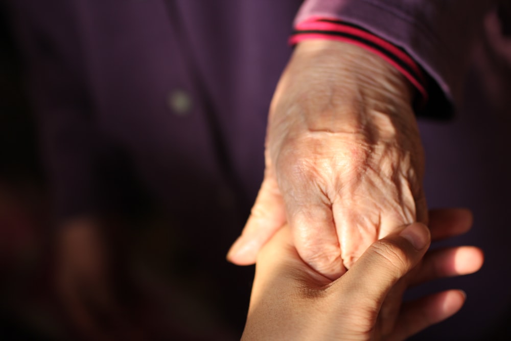 Colored image of two hands holding