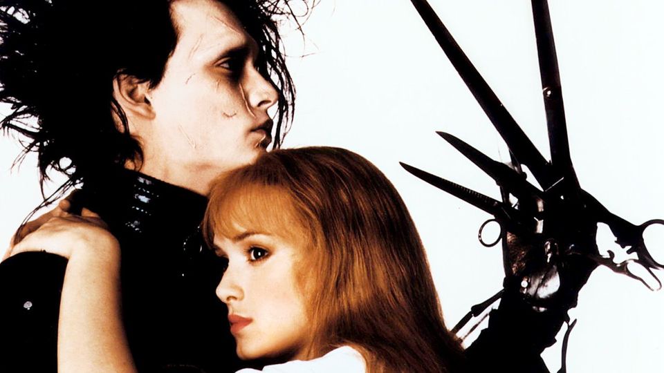 A poster for Edward Scissorhands shows the central charachter holding up his hands.