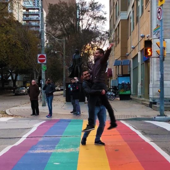 Two men in Torontos gay village, a safe city for LGBTQIA+ travelers.