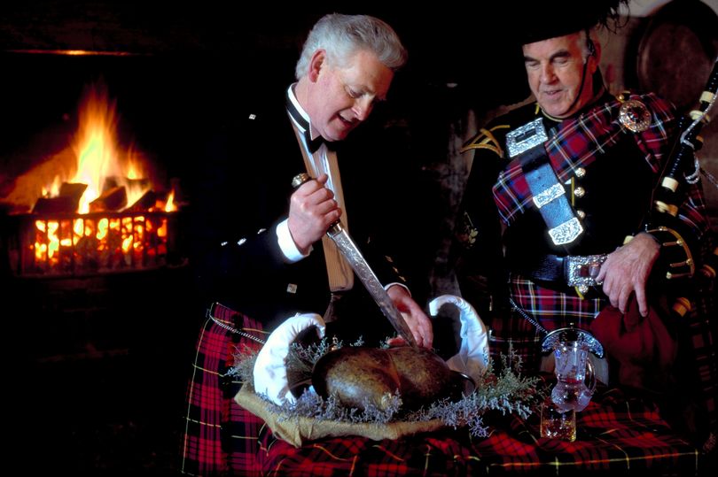 Coloured image of two men preparing haggis to be served for Burns Supper