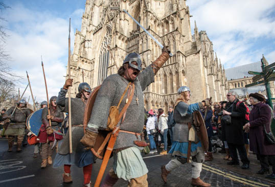 Color image of Jorvik Viking Festival members on the street of York, England