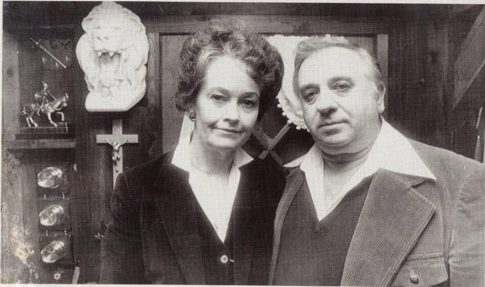 A black and white photograph of Ed and Lorraine Warren in the Ocult Museum.